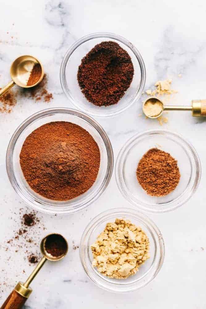 Spices in individual clear bowls. 