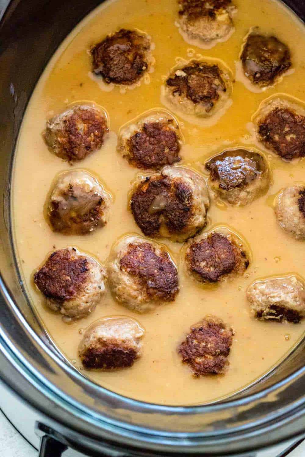 Swedish meatballs simmering in a slow cooker