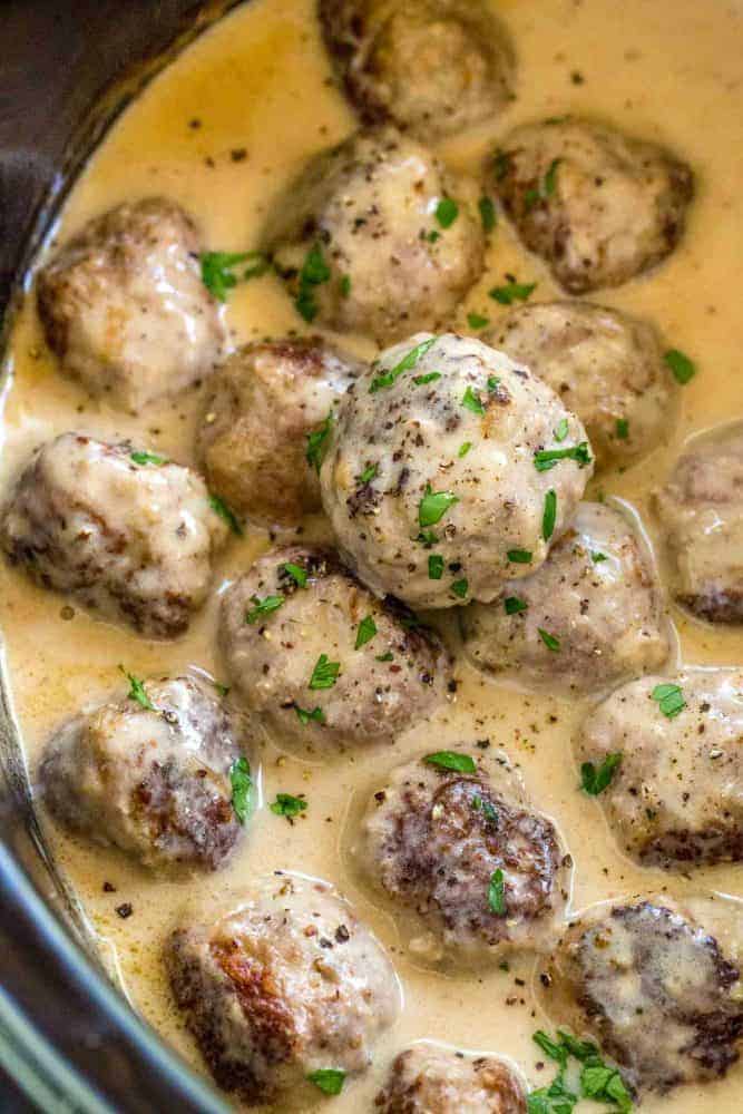 Swedish meatballs cooking in a crock pot.