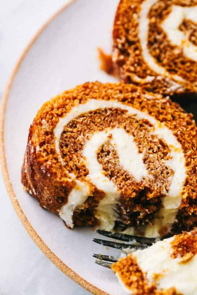 Slices of Pumpkin Roll on a white plate. 