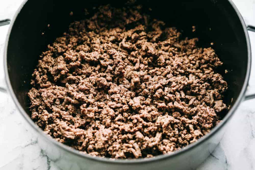 Cooked ground beef in a large pot. 