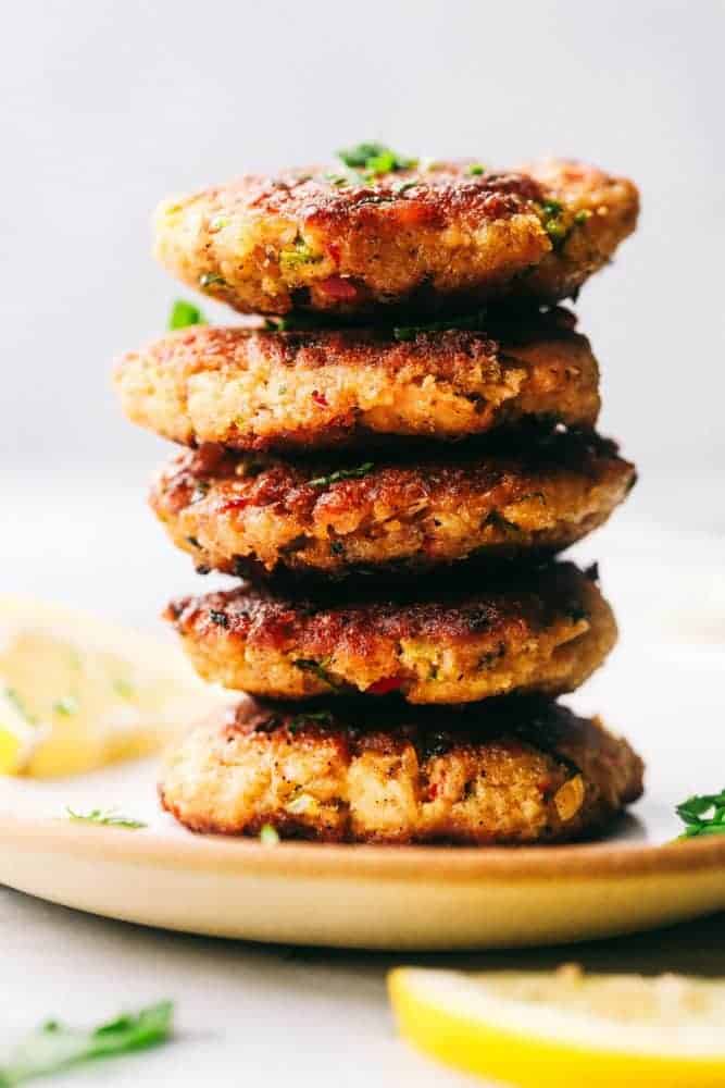 Salmon croquettes stacked on top of one another.