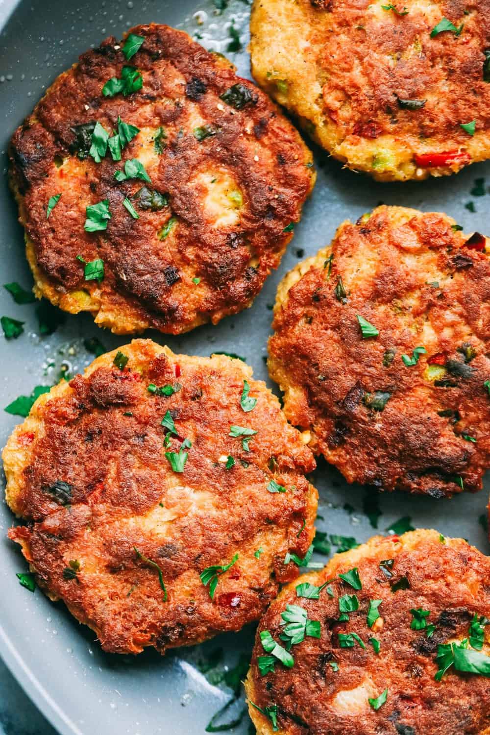 Close up of Salmon Croquettes in a frying pan. 