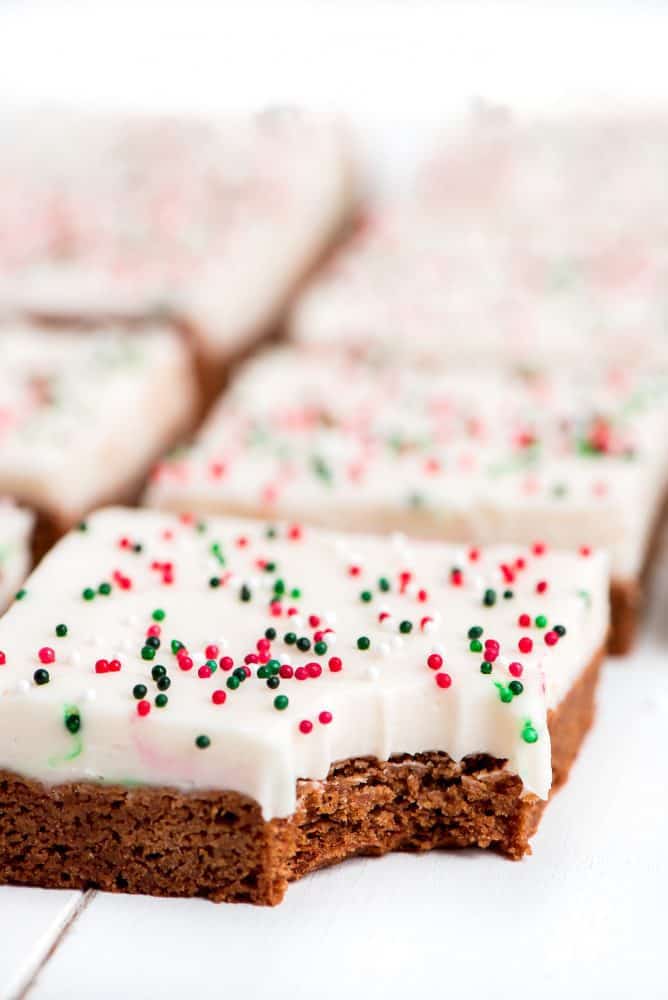A gingerbread sugar cookie bar with a bite taken out of the corner.