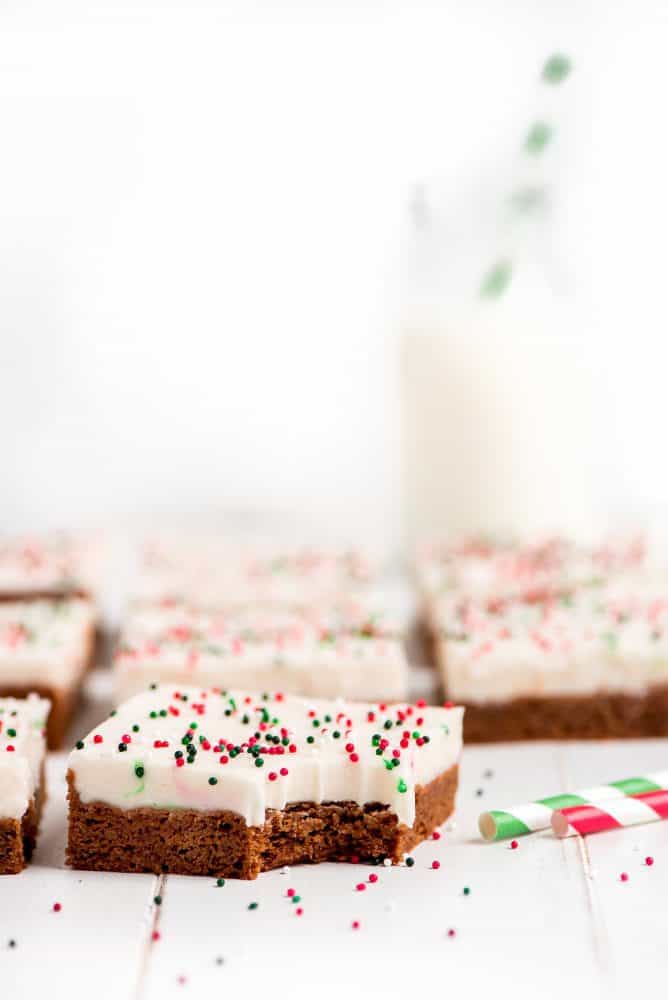 A gingerbread sugar cookie bar taken a bite out of.