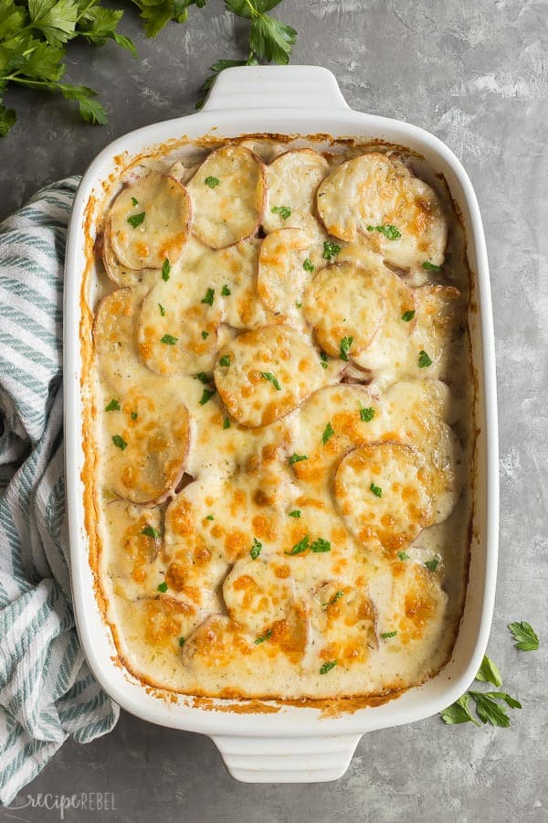 scalloped potatoes and ham in white dish