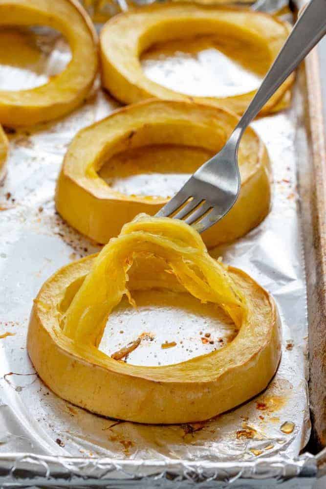 roasted spaghetti squash rings on a foiled-lined sheet pan