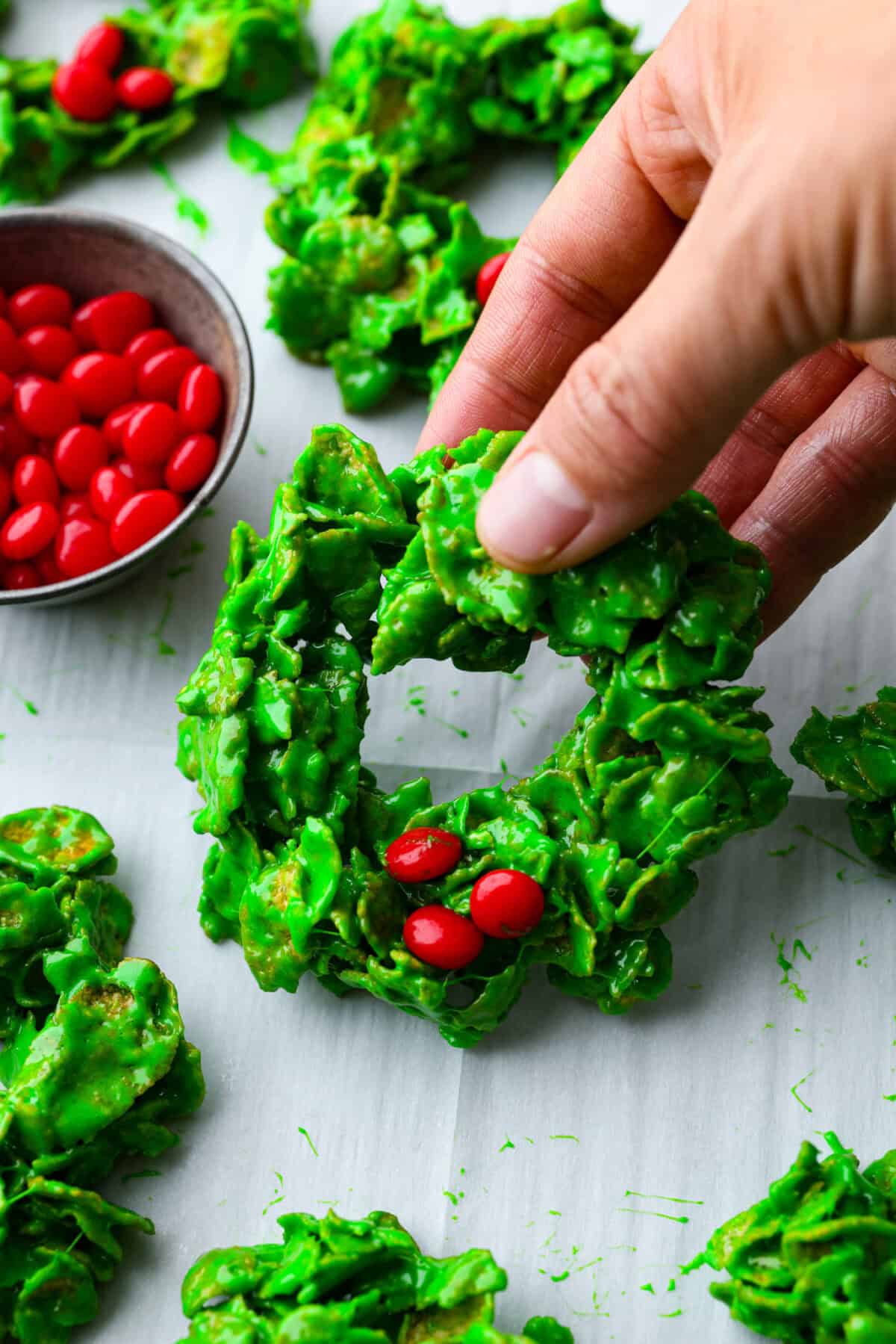 Close up shot of someone picking up a Christmas cornflake wreath. 