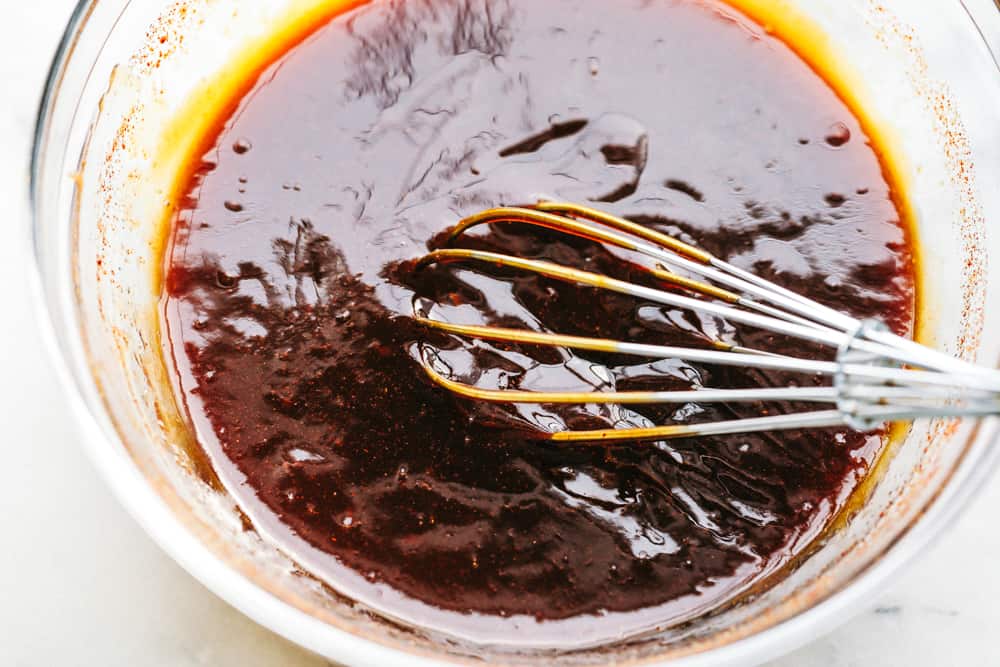 Whisking slow Cooker BBQ sauce.