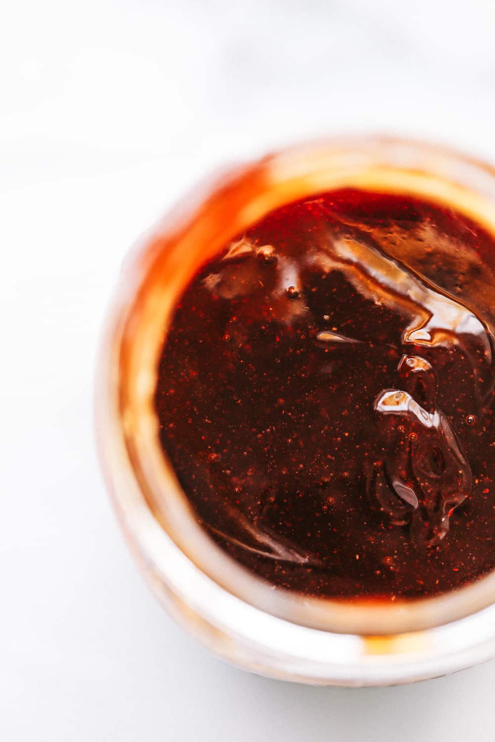 close up on homemade BBQ sauce in a jar.