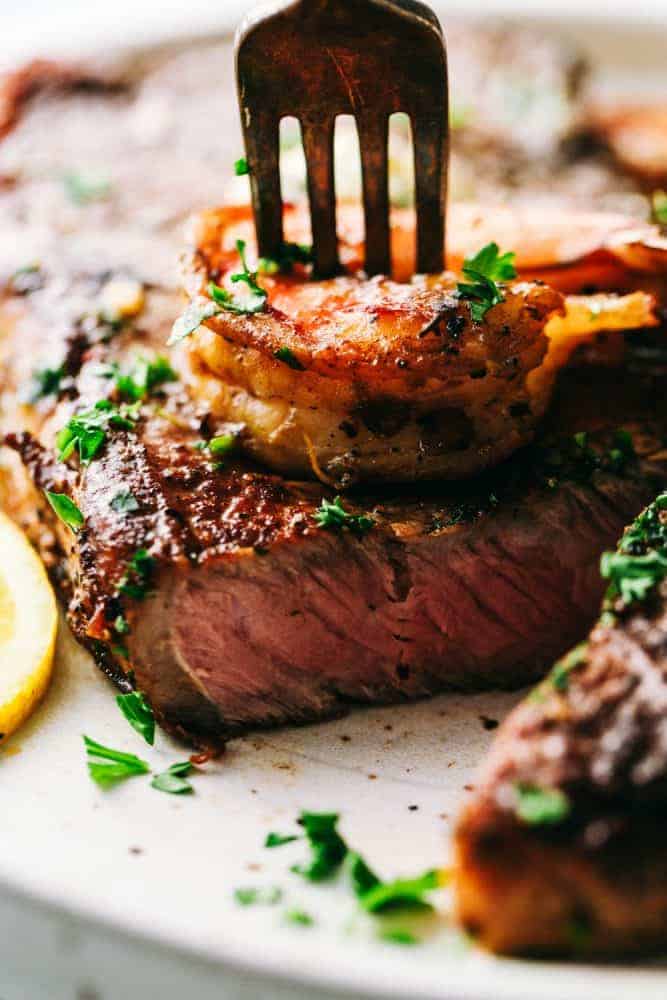 Steak and shrimp bites on a fork.