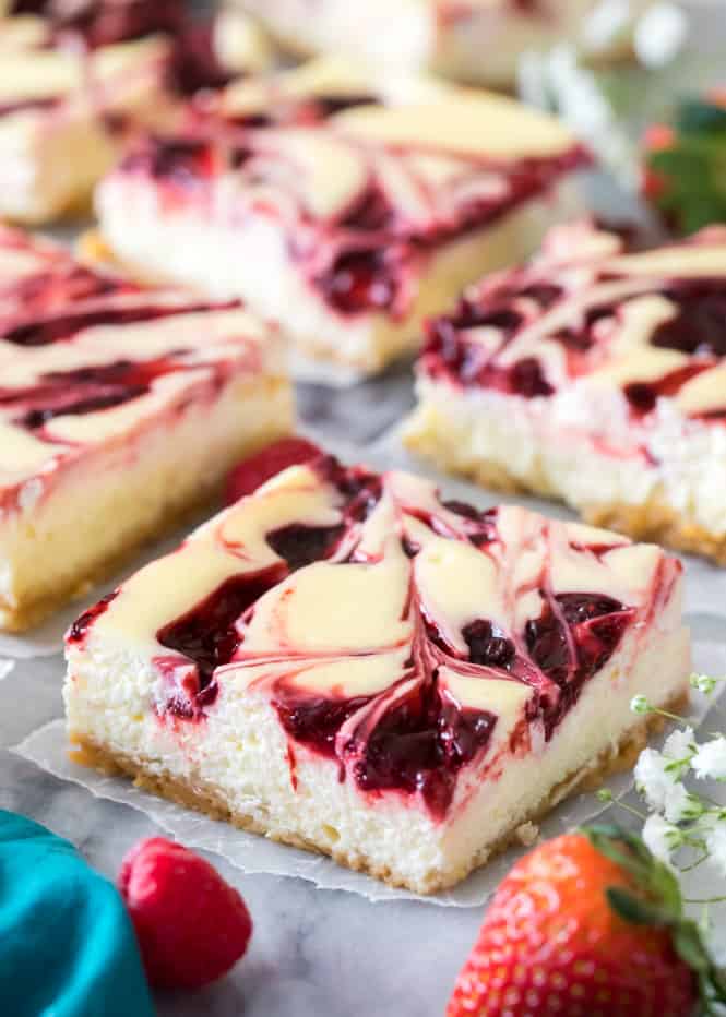 sliced cheesecake bar with raspberry swirl