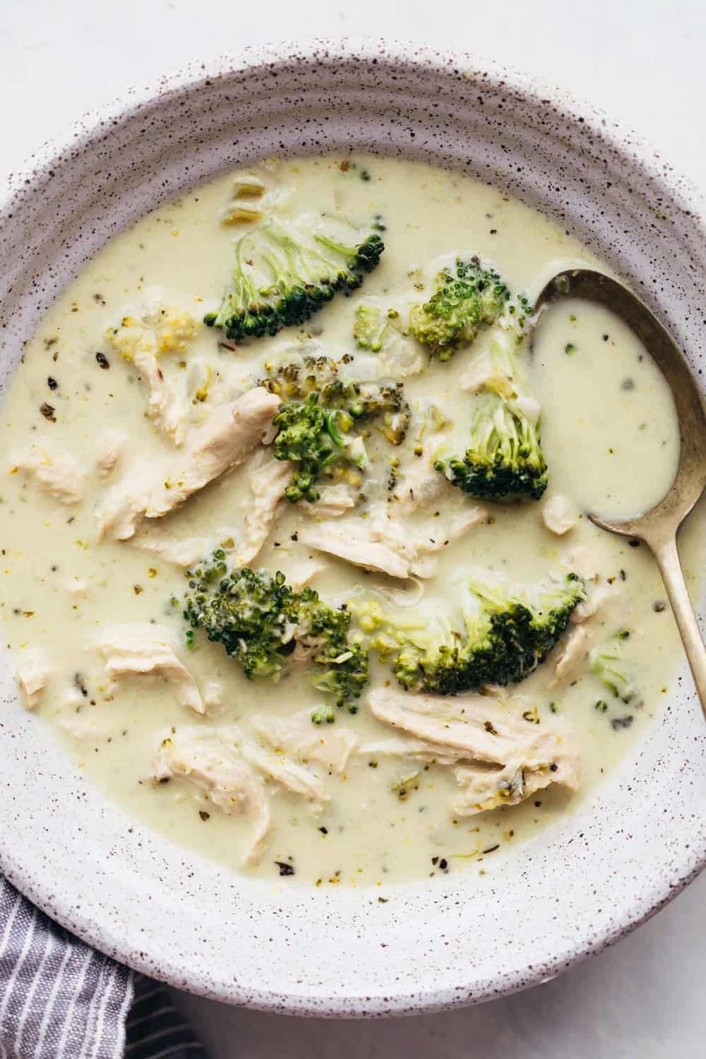 Creamy chicken broccoli soup in a bowl with a spoon