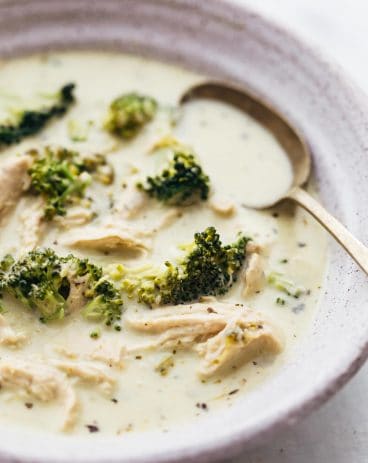 Closeup of creamy chicken broccoli soup in a bowl with a spoon