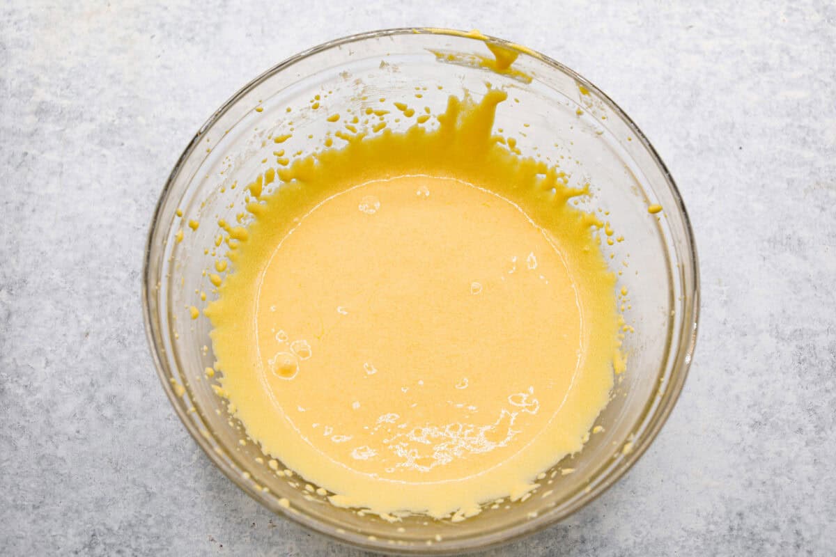 Overhead shot of whipped egg yolks and sugar in a bowl. 