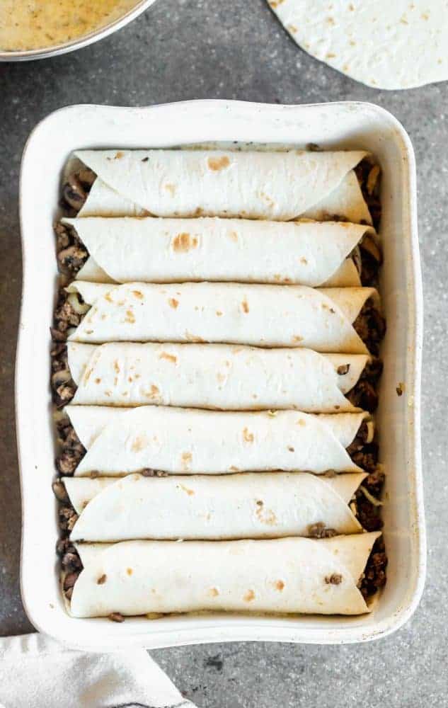 Enchiladas in a baking dish.