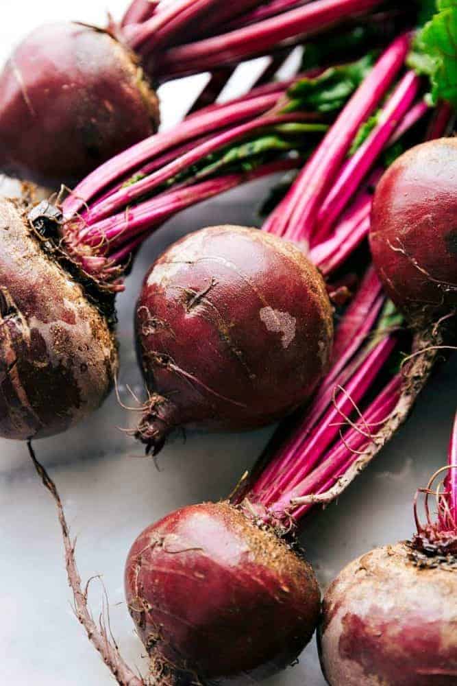 Beets laying on a counter.