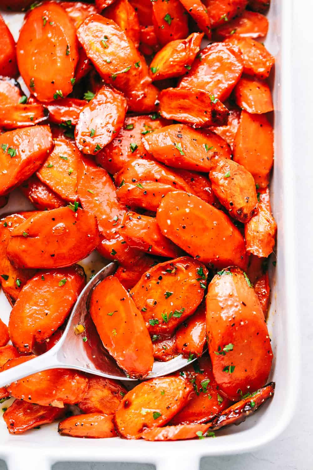 Best Ever Glazed Carrots being scooped up by a spoon.