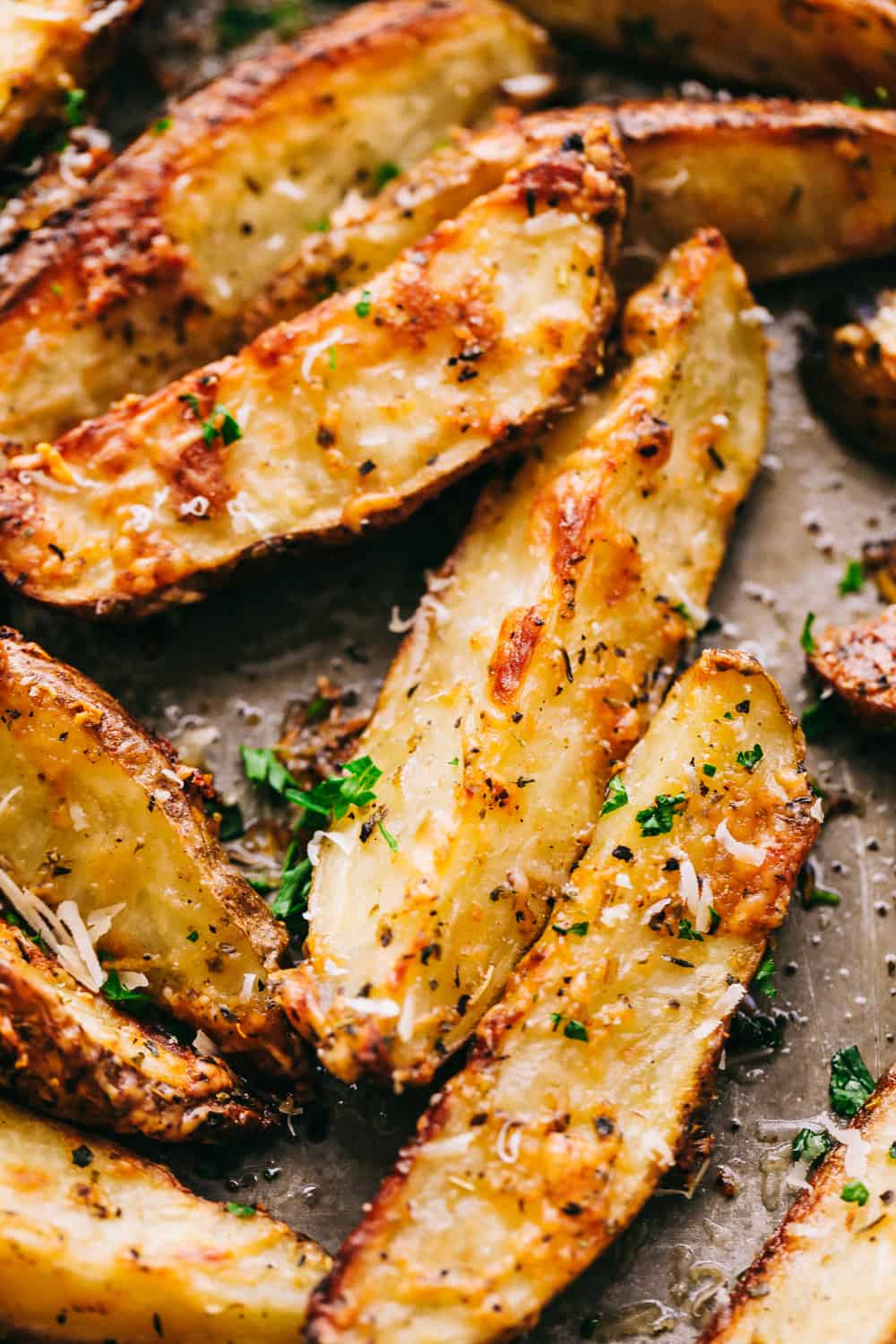 Baked Parmesan Garlic Potato Wedges on a tray.