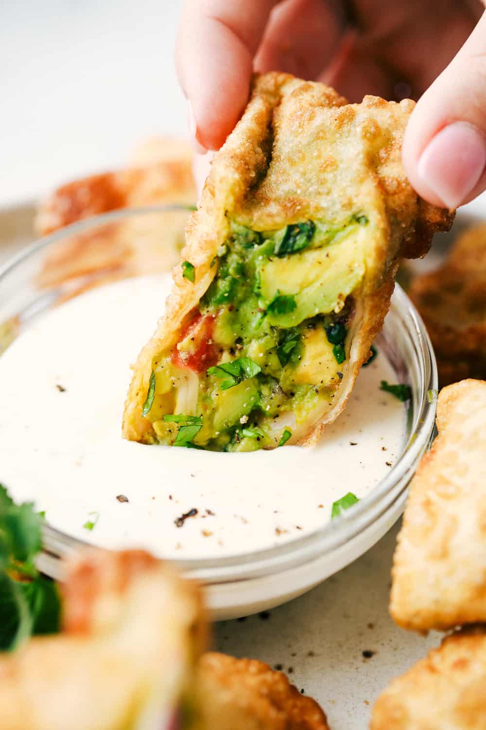 Dipping avocado egg roll.