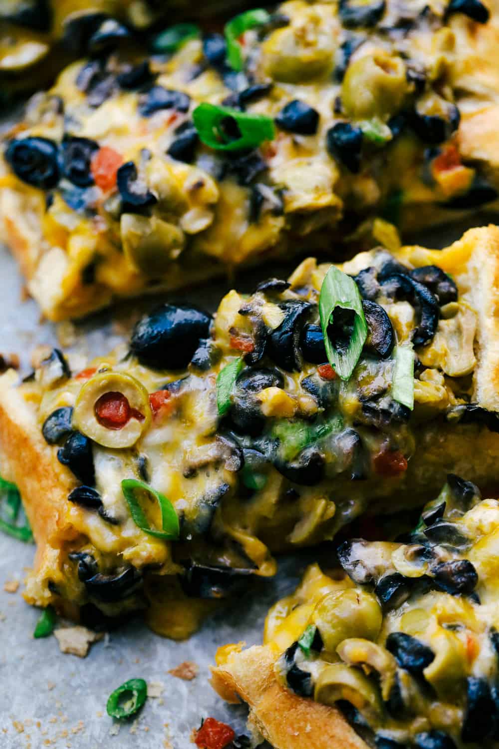 Close up of cheesy olive bread.