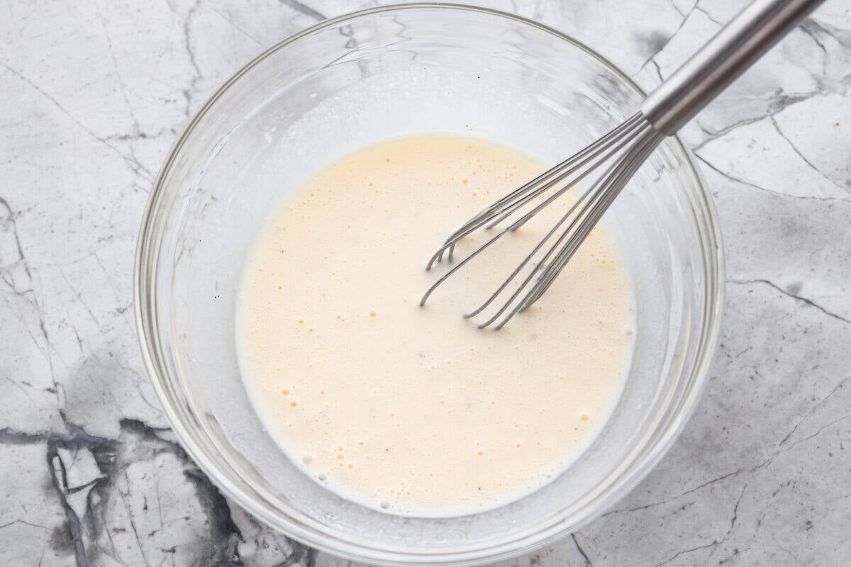 Coleslaw dressing ingredients whisked together in a bowl. 