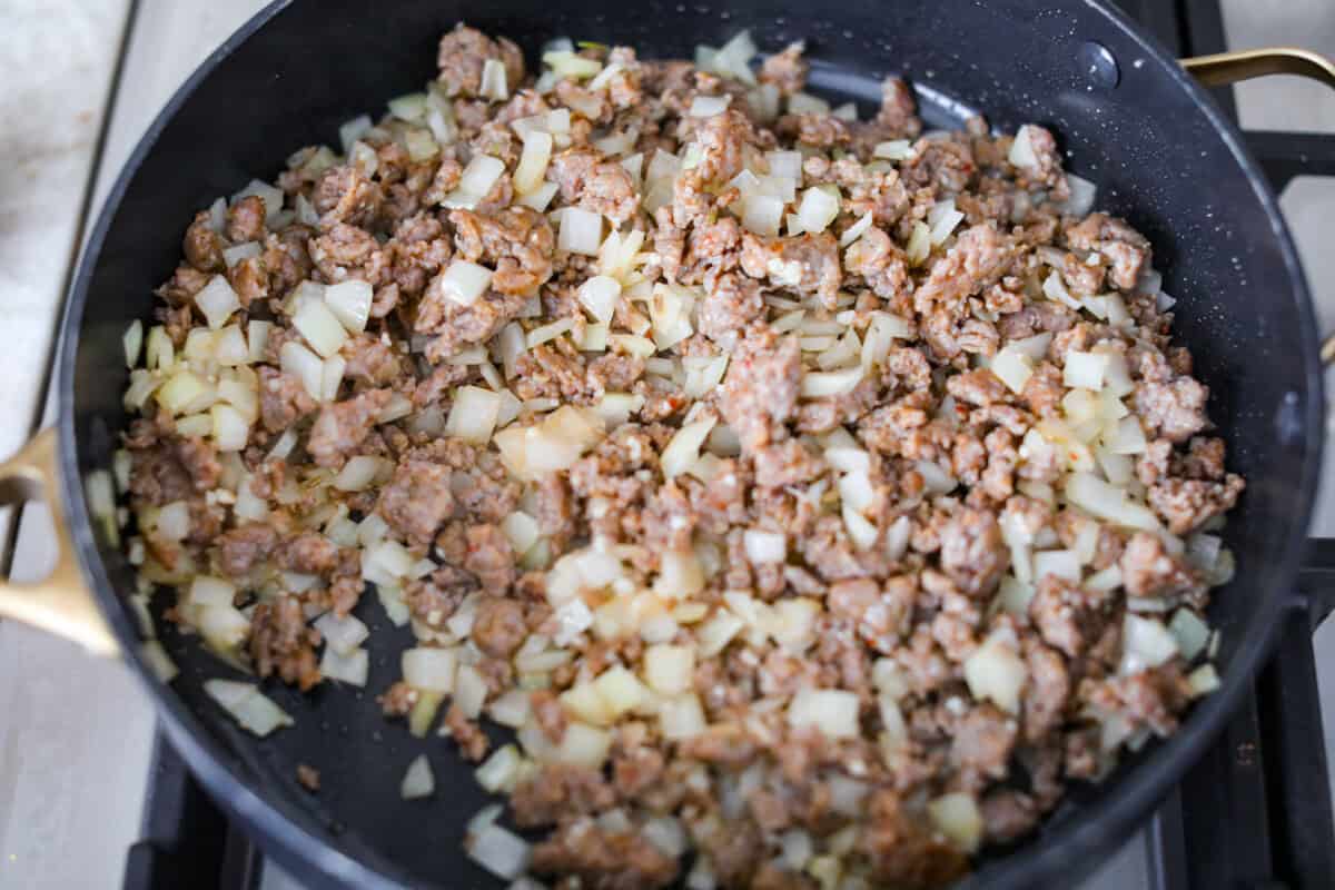 Onions and garlic cooking with the Italian sausage.