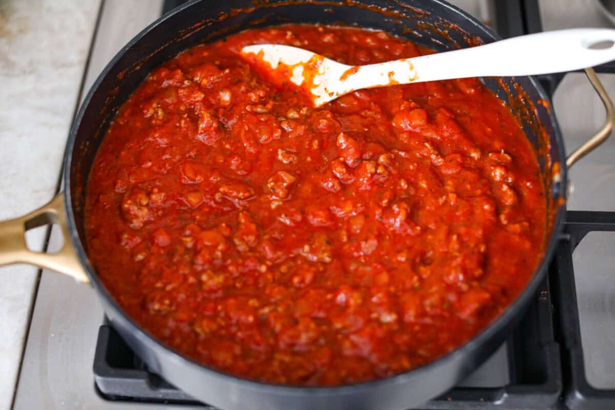 Overhead shot of marinara added to the meat and onion mixture. 