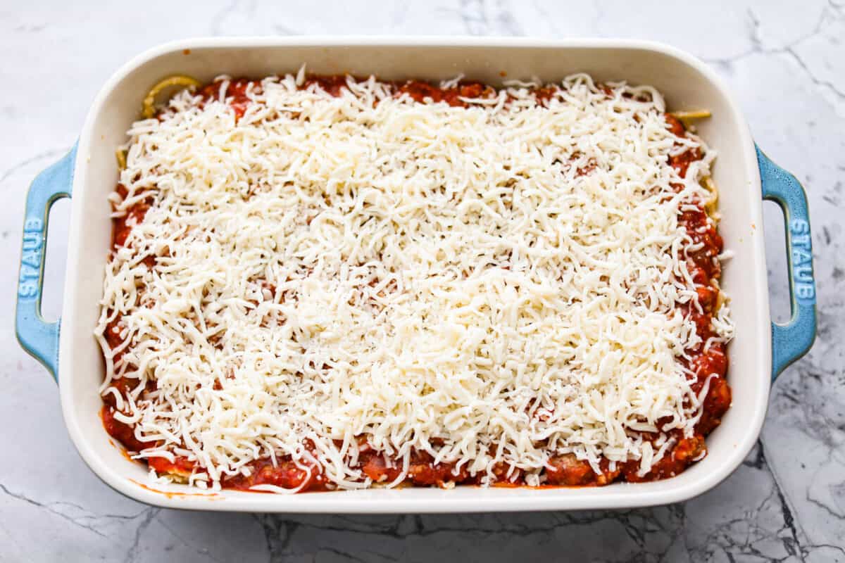 Layer of cheese on top of the meat sauce and noodle layers. 