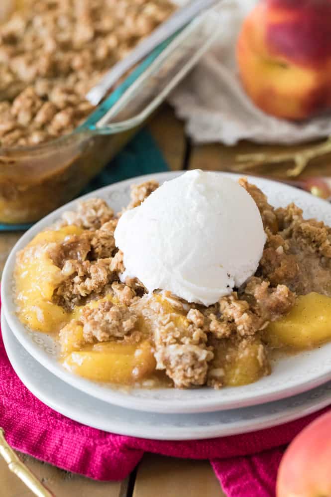 Peach crisp topped with vanilla ice cream