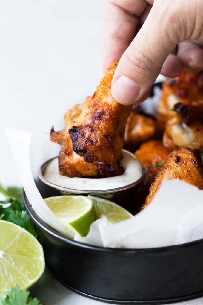 Chili Lime Chicken Wings dipped in sauce