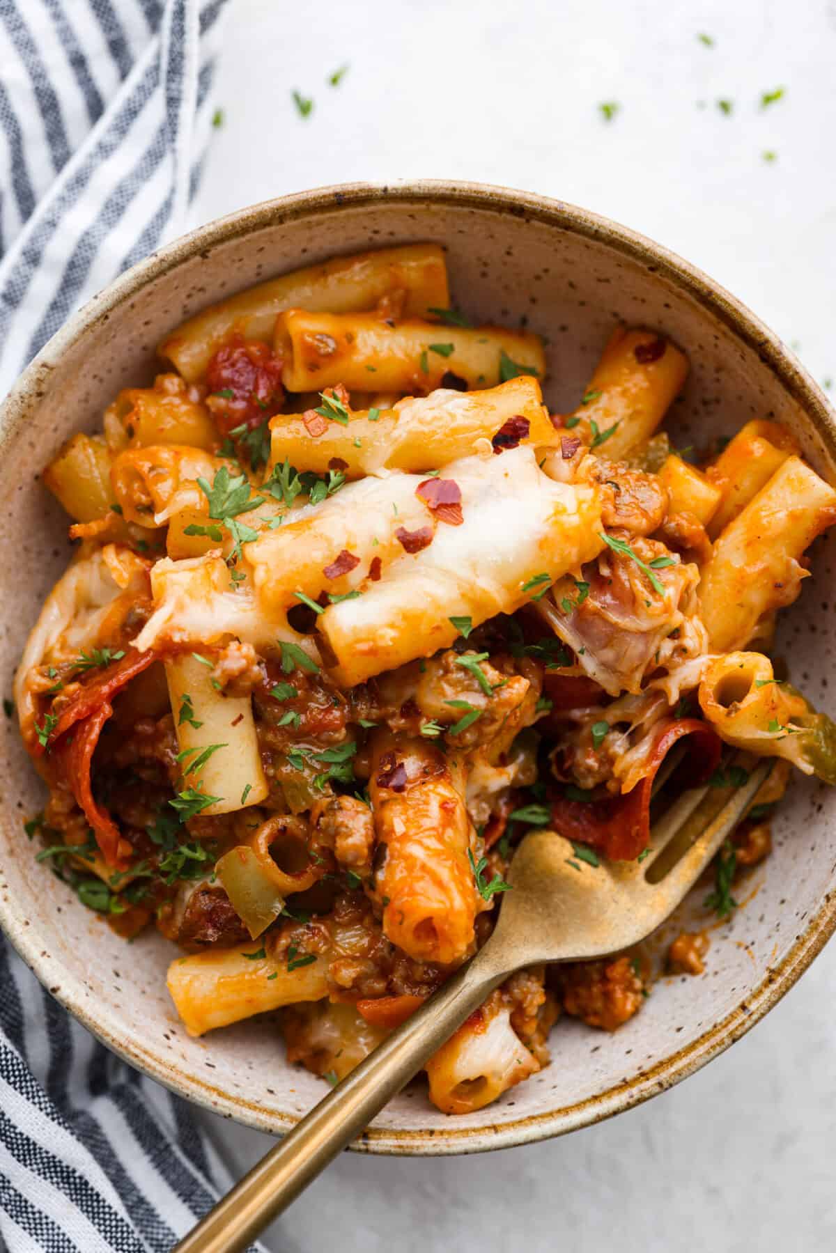 Overhead shot of plated cheesy baked ziti. 