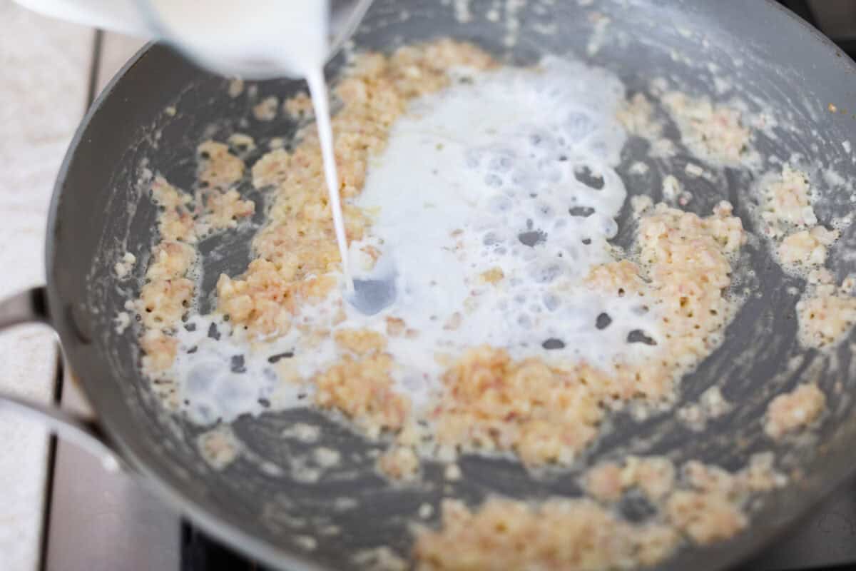 Fourth photo of the milk adding to the saucepan.