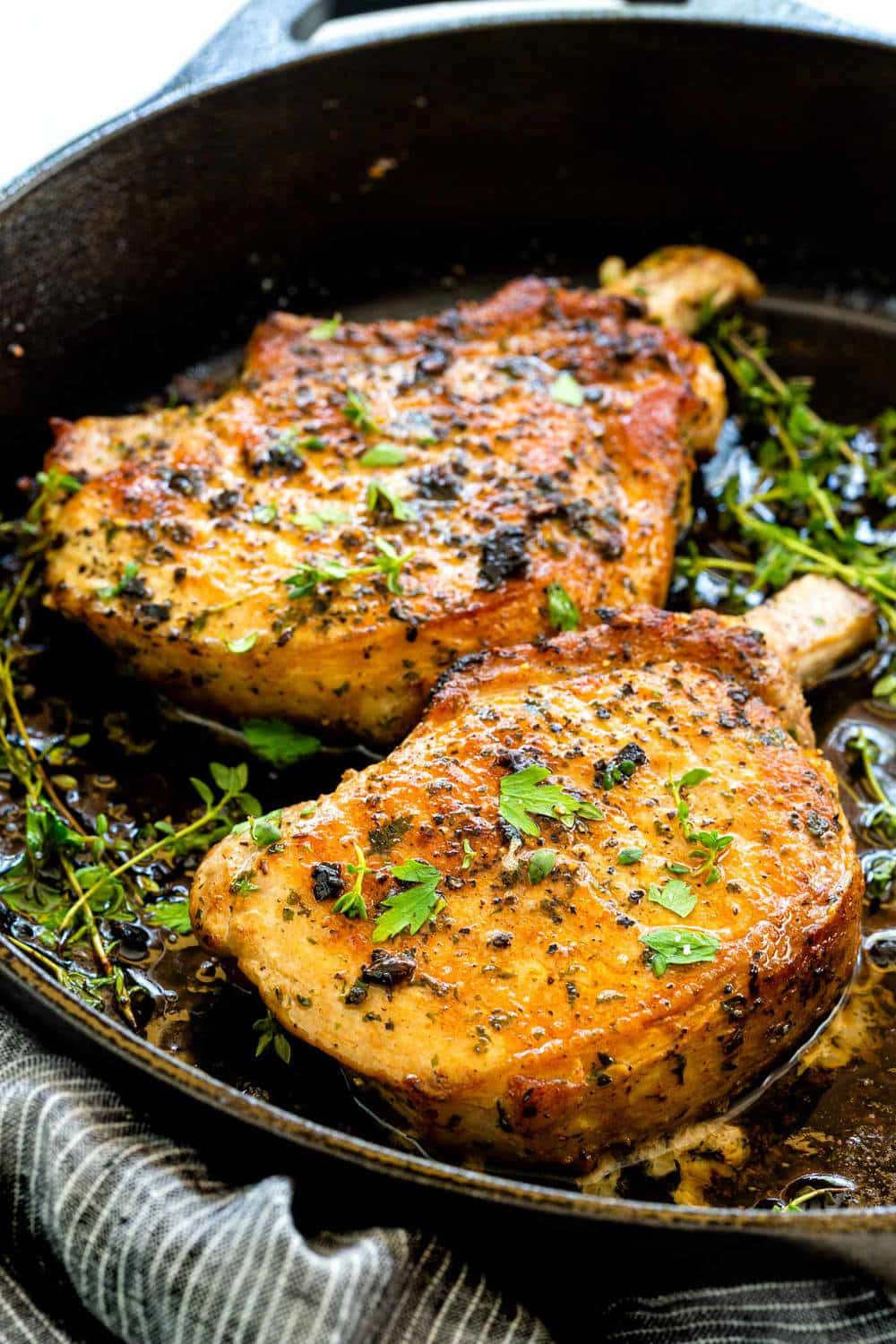 pork chops cooked in a cast iron skillet