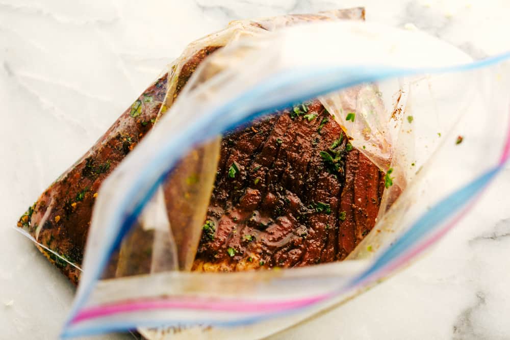 steak marinating in a ziplock bag
