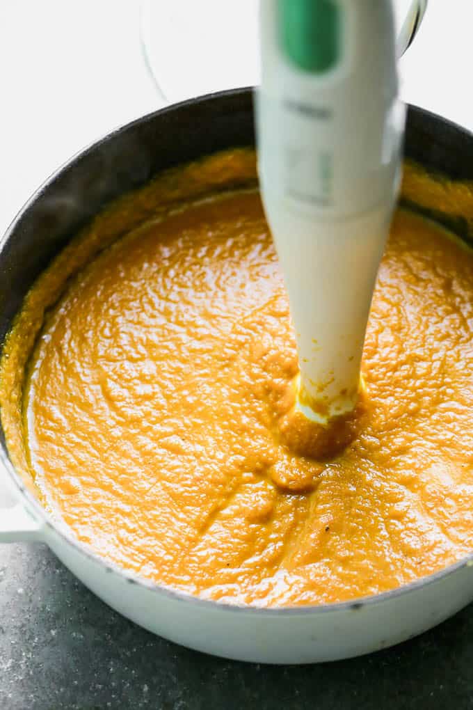 Blending the pumpkin soup in a pot