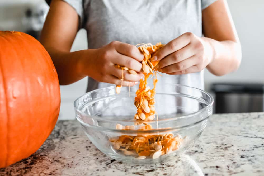 Separating the pumpkin seeds from the membranes. 