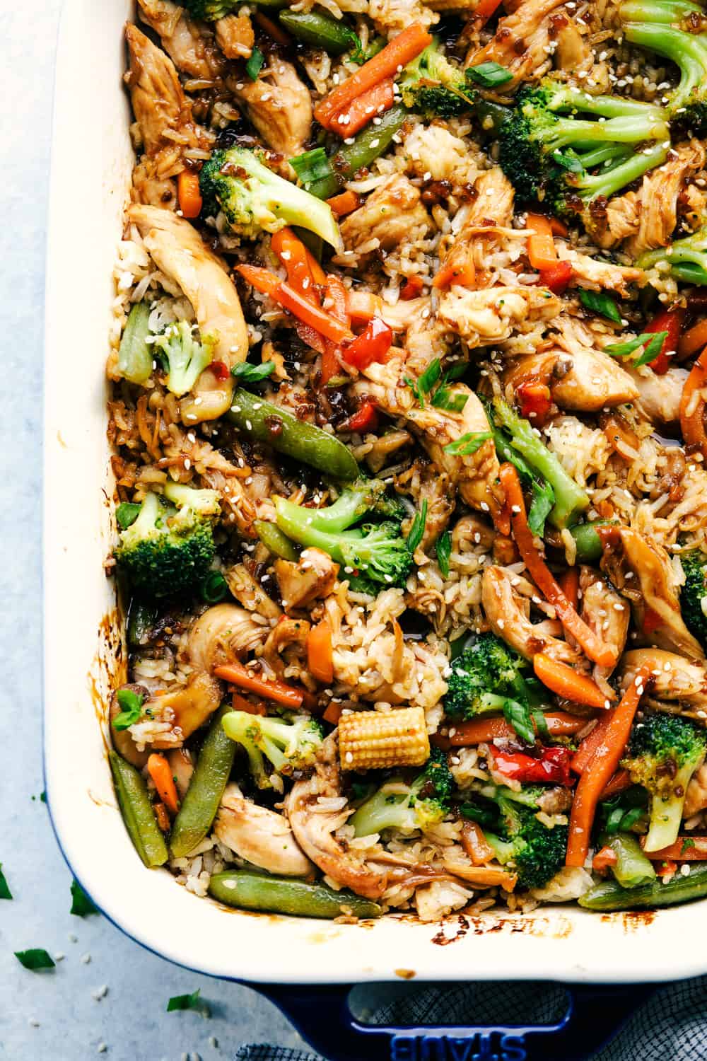 Easy Teriyaki Chicken Casserole isย a simple casserole made with homemade teriyaki sauce, vegetable stir fry and rice that's all baked to perfection. A savory dish that everyone loves!ย Top-down view of easy teriyaki chicken casserole.