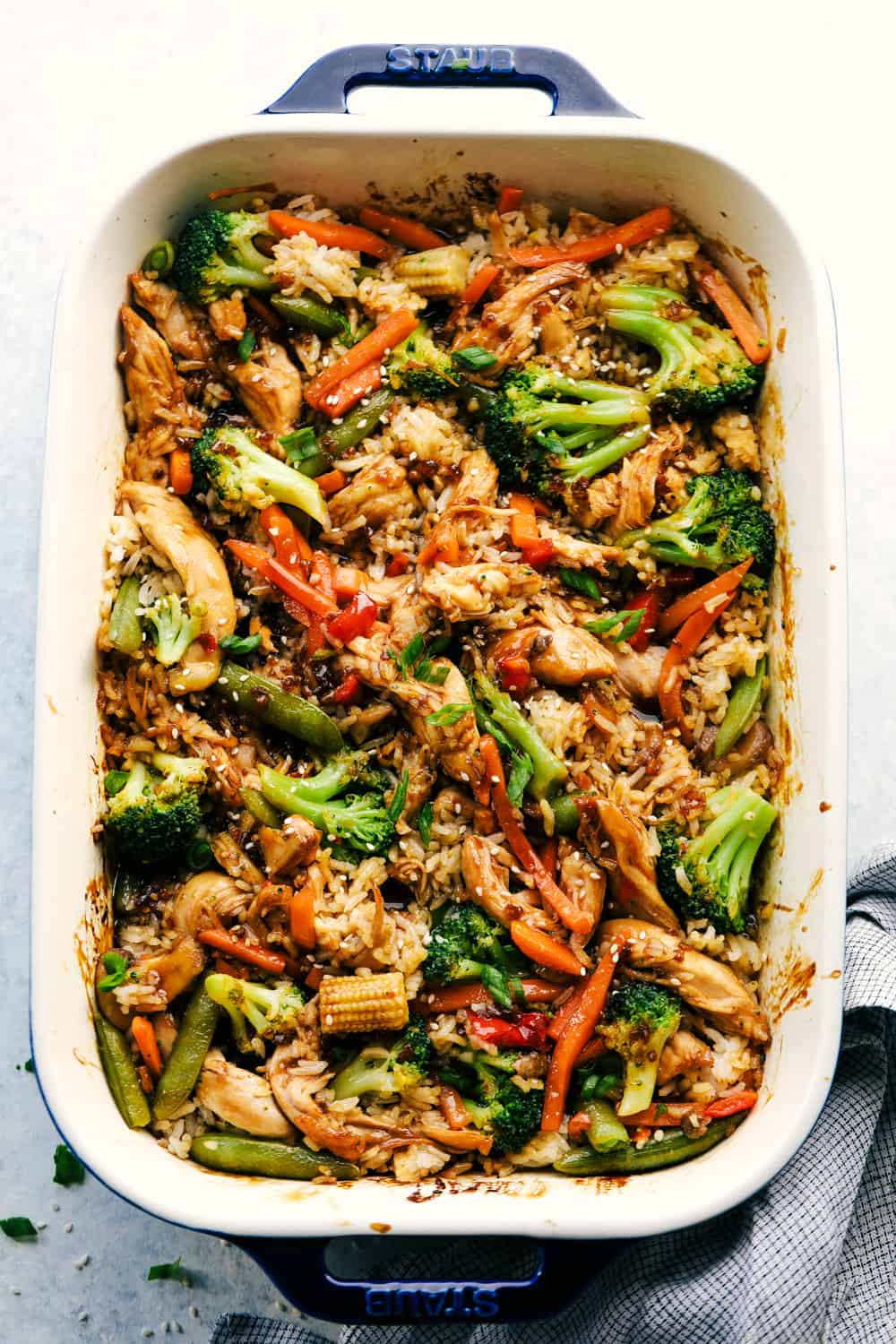 Chicken teriyaki casserole in a blue and white baking dish.