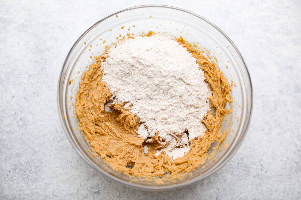 Overhead shot of the wet ingredients with the dry ingredients dumped on top. 