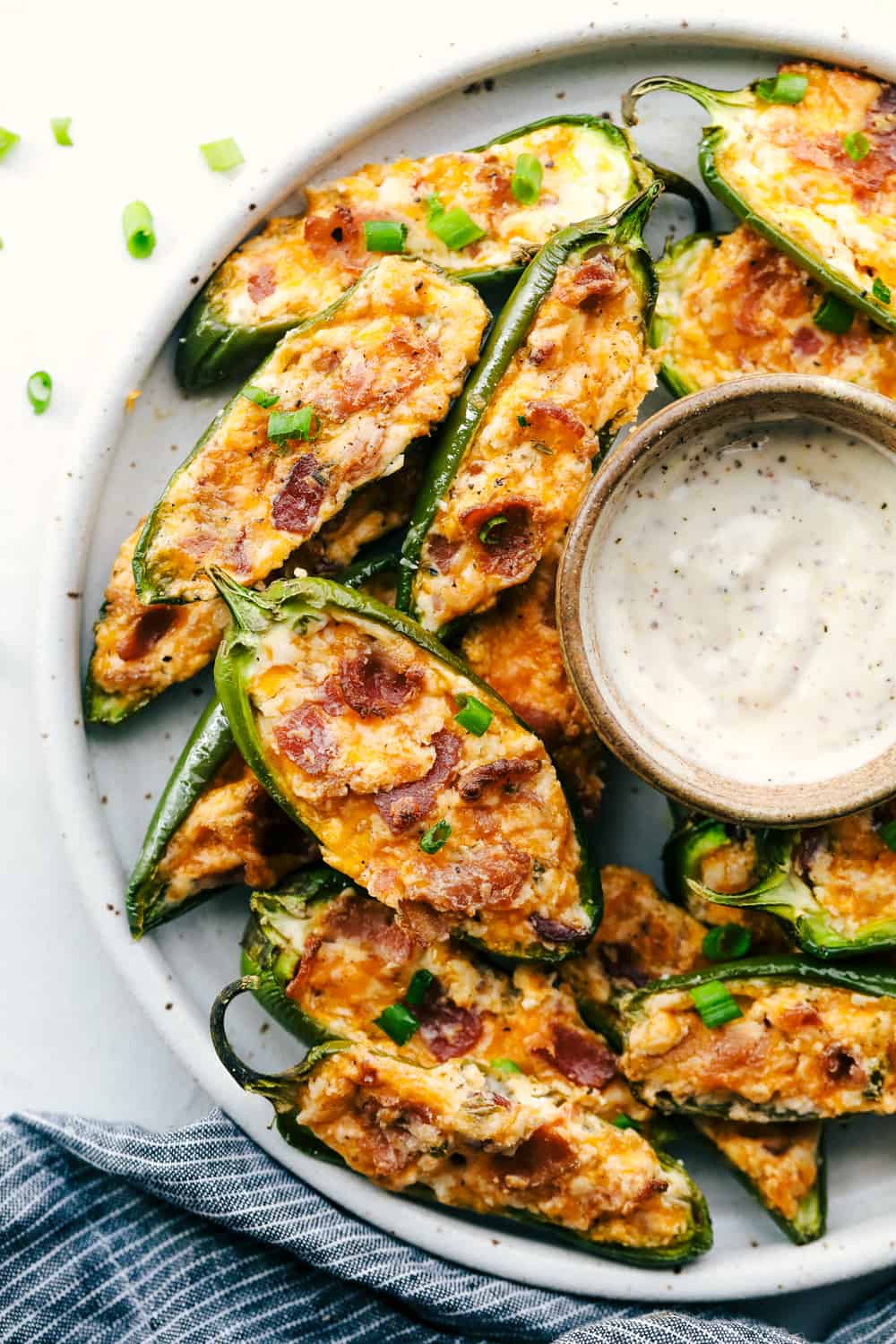 jalapeno poppers with dip on a plate 