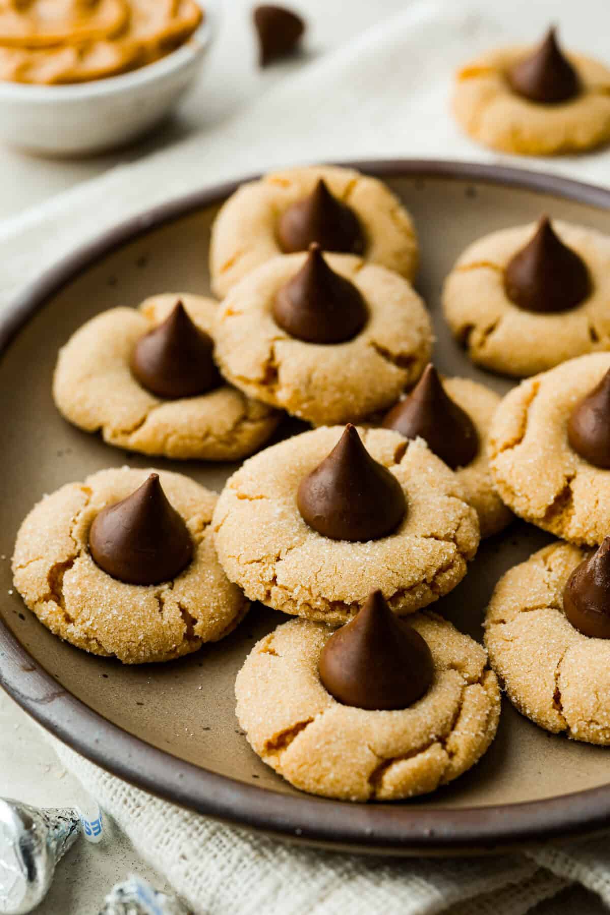 Angle shot of peanut butter blossom cookies on a serving platter. 