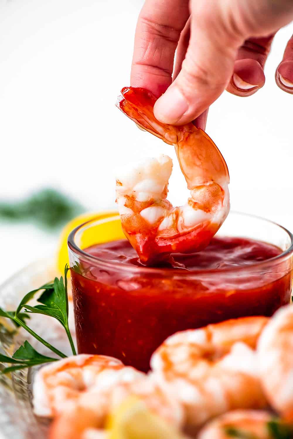 shrimp dipped in cocktail sauce