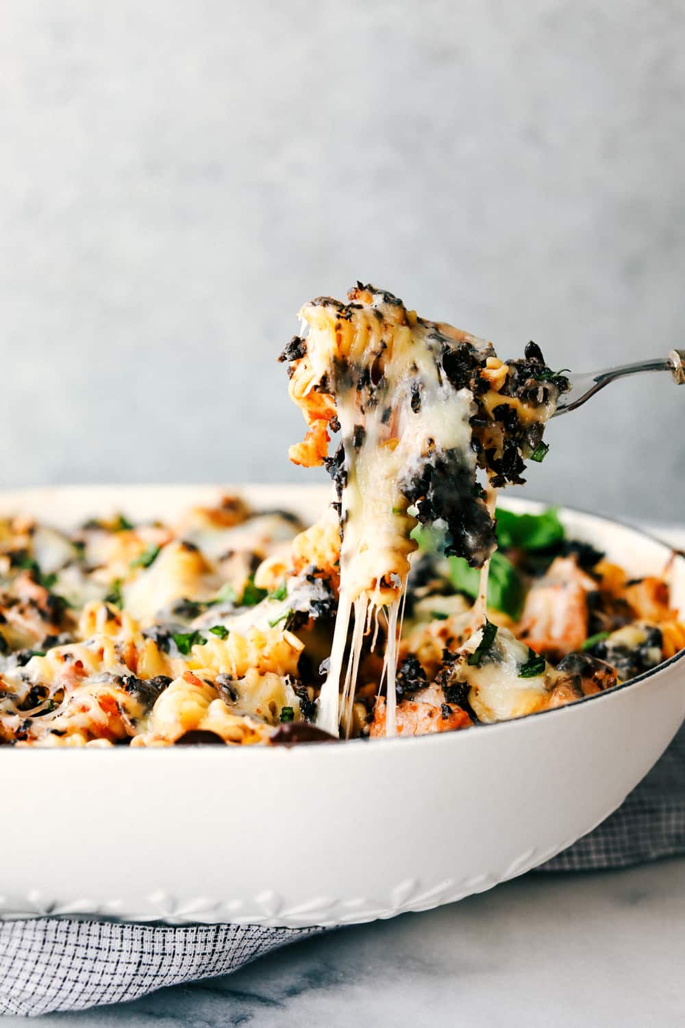 Turkey Mediterranean casserole in a dish with a fork pulling it away. 