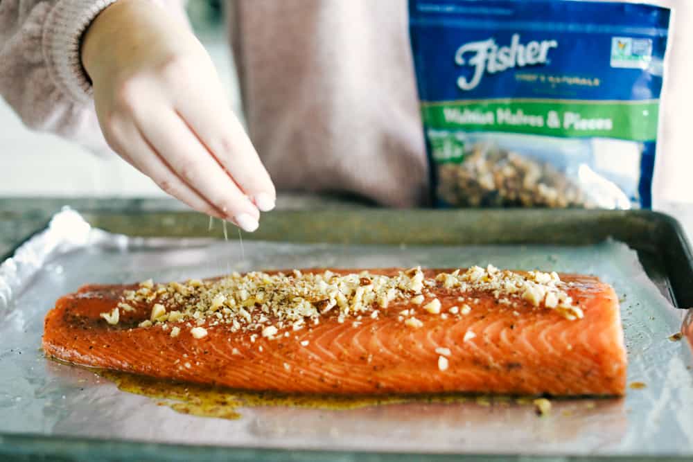 Walnut crusted maple salmon having fisher walnuts sprinkled over top. 