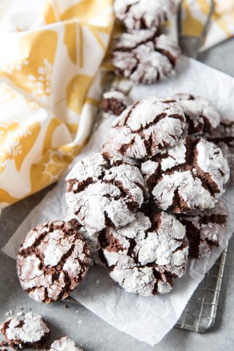 Chocolate crinkle cookies on a wire grate