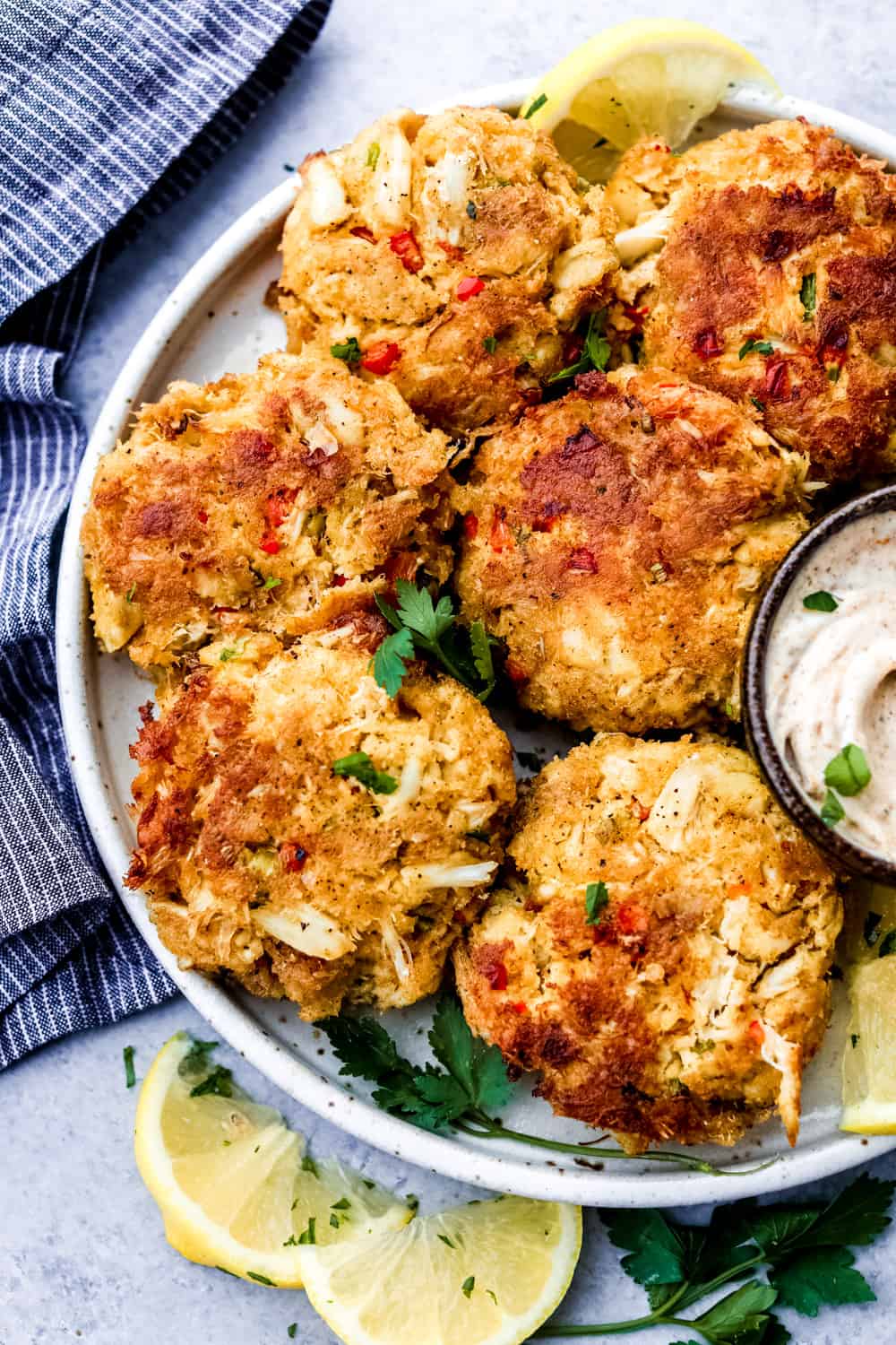 Crab cakes on a white plate.