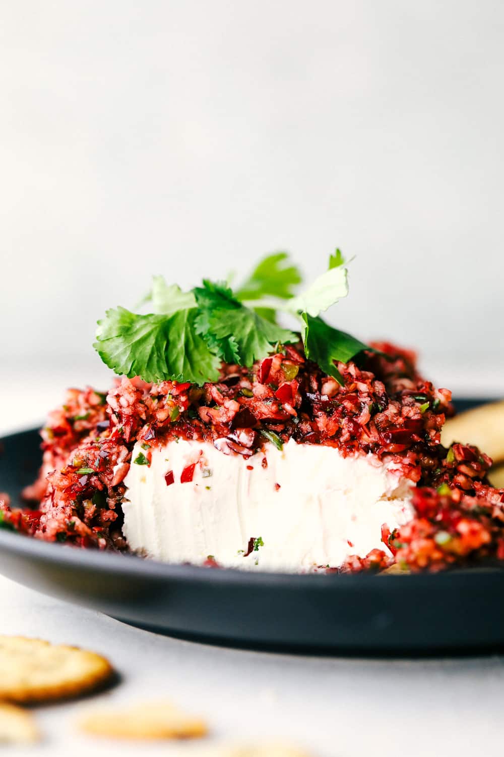 Cranberry salsa over top of a cream cheese block. 