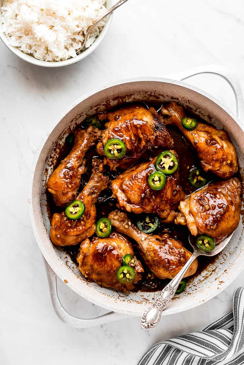 Chicken Adobo in a pot garnished with jalapeños 