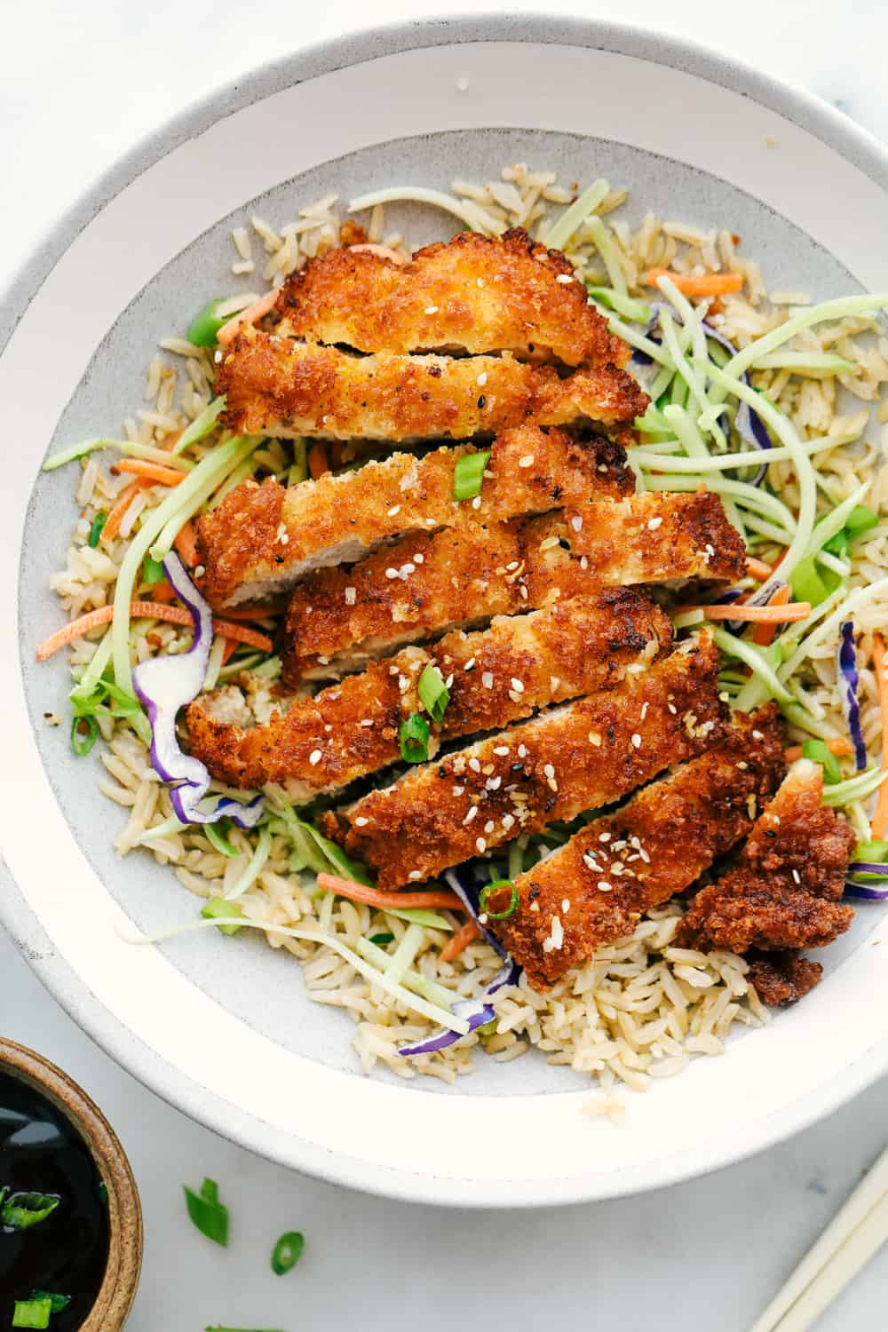 Chicken Katsu chopped in slices and added over top cabbage and rice. 